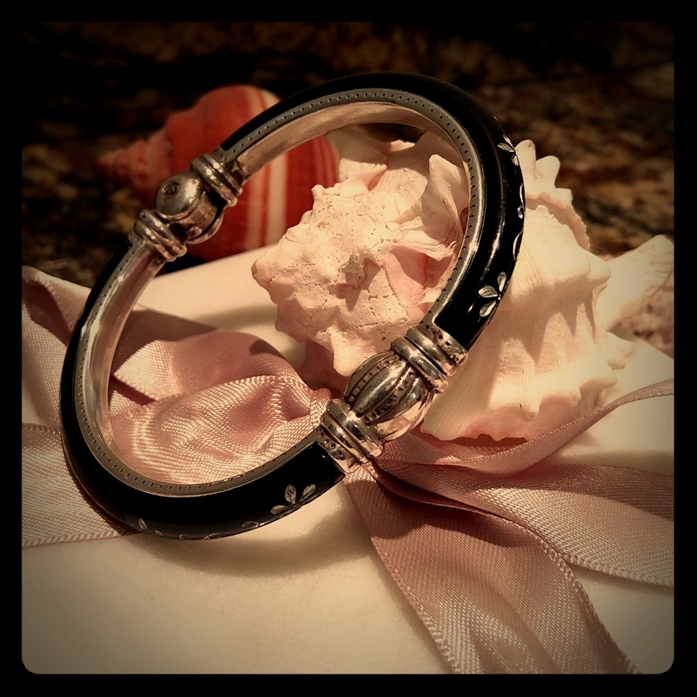 Hinged black enameled bracelet with flower design